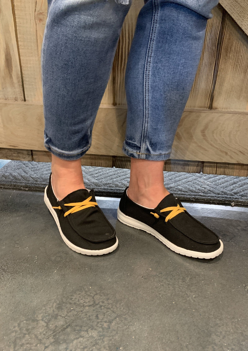 Black and yellow slip on shoe